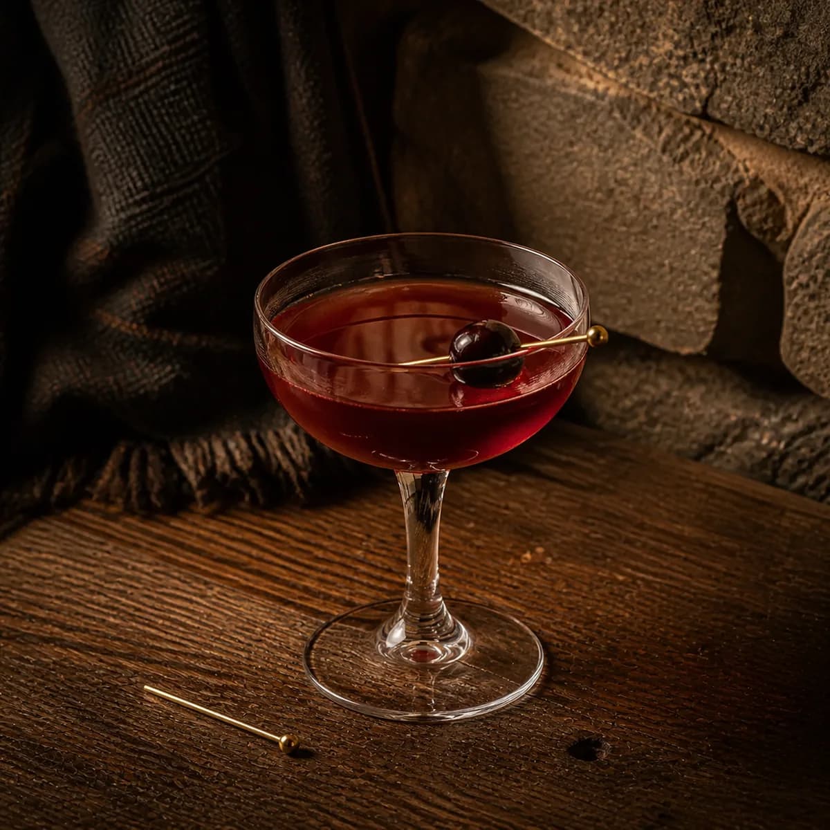 Brooklyn in a clear shallow coupe styled in a mountain lodge bar with timeworn oak, dark wool and rough local stone.