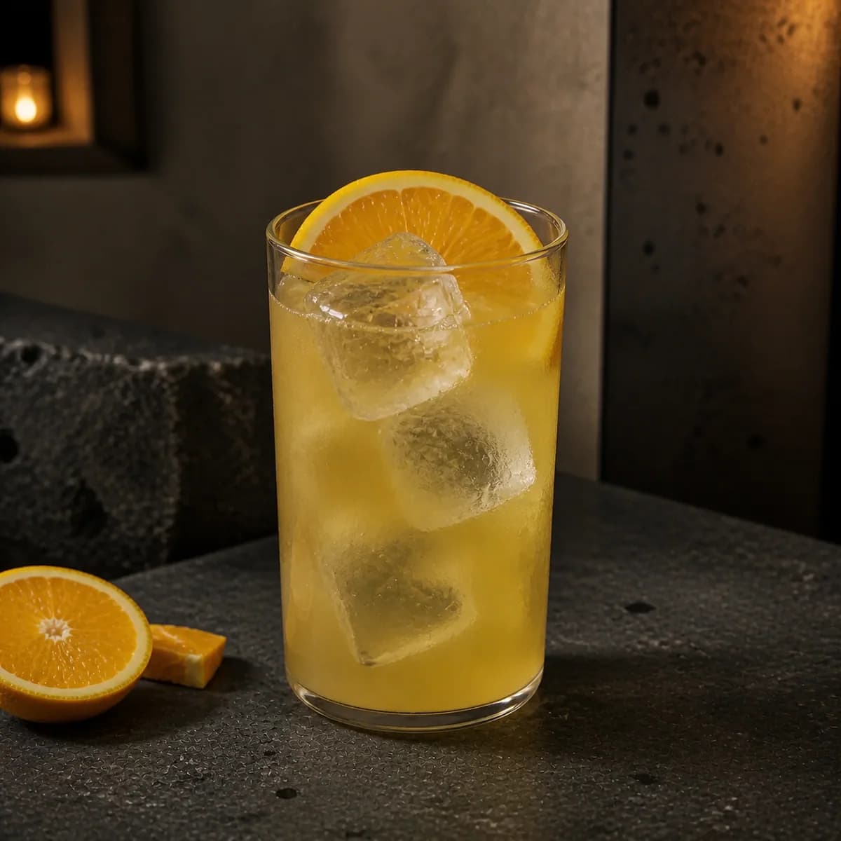 Freddy Fudpucker in a tall straight-sided highball glass styled in a restrained modern mezcalería with blackened steel, pale clay render and rough volcanic stone.