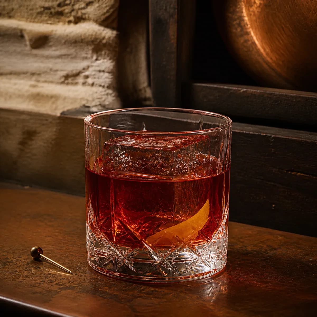 French Connection in a heavy low rocks glass styled in an intimate cellar salon with limewashed masonry, old oak and tarnished copper.