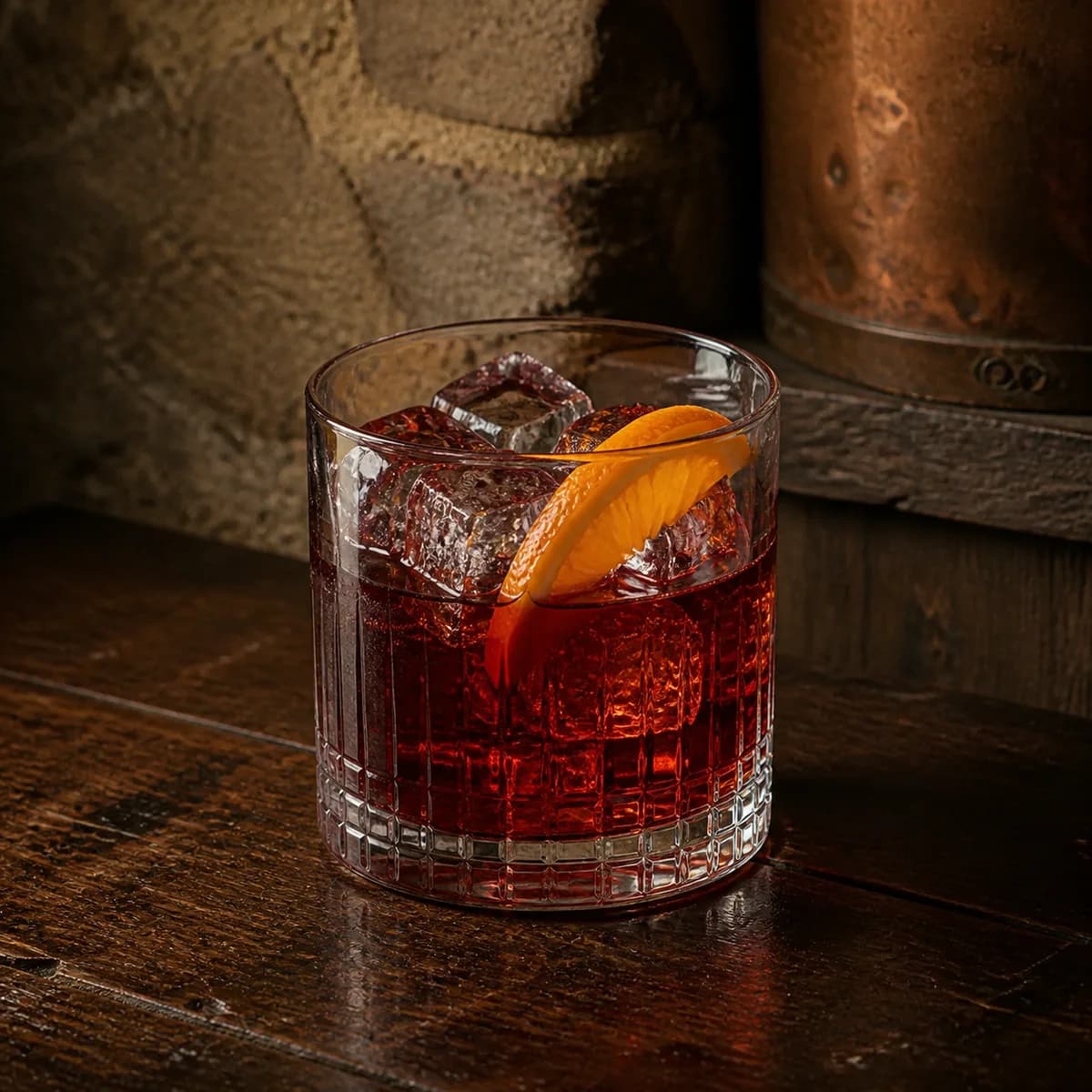 Harvard in a heavy low rocks glass styled in an intimate cellar salon with limewashed masonry, old oak and tarnished copper.