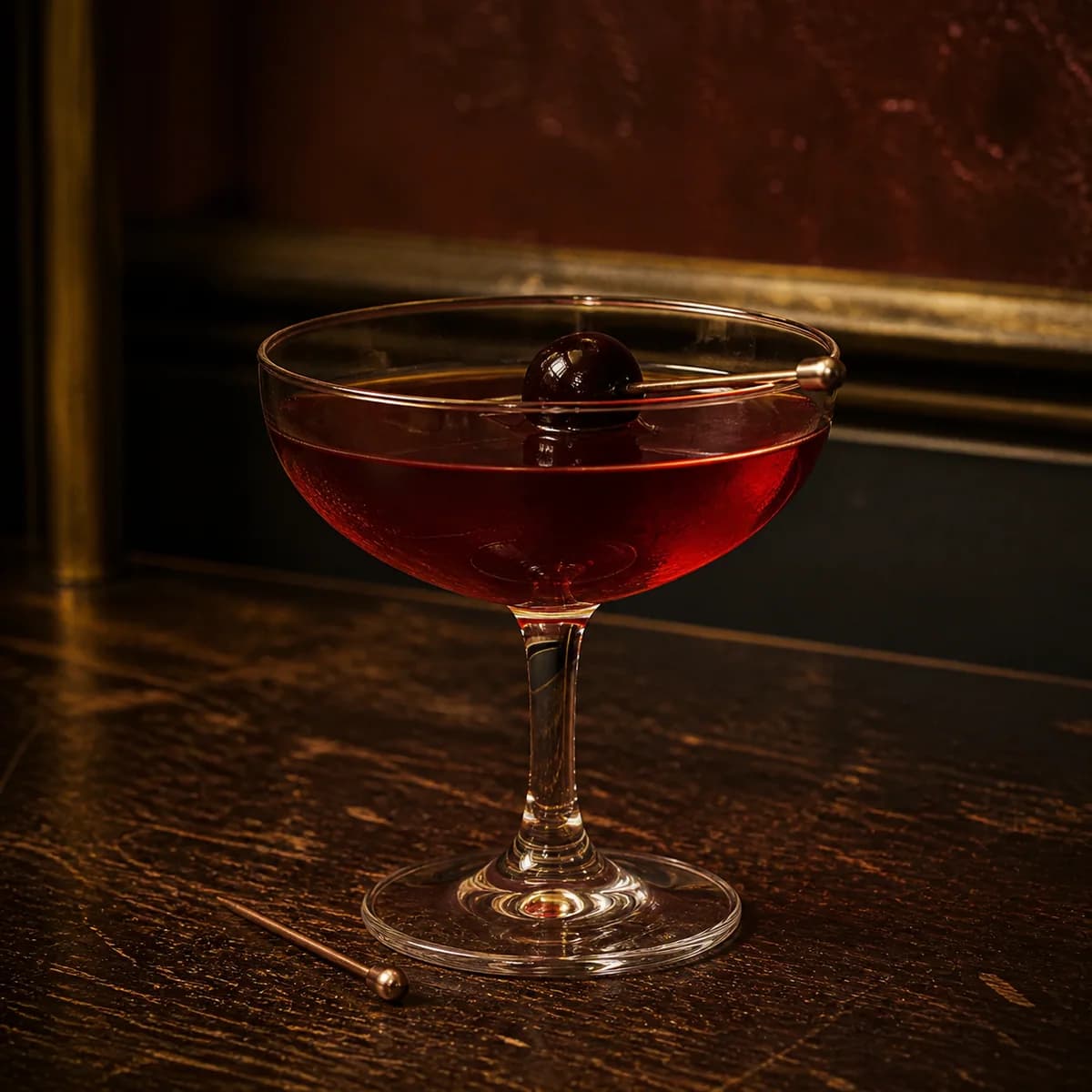 Remember the Maine in a clear shallow coupe styled in a small jazz bar with oxblood plaster, old brass trim and scratched dark wood.